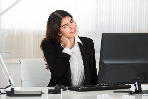 Woman with neck pain from sitting at the computer